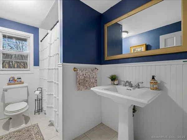 a bathroom with a sink toilet and mirror
