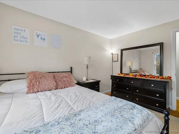 a bedroom with a bed and a mirror