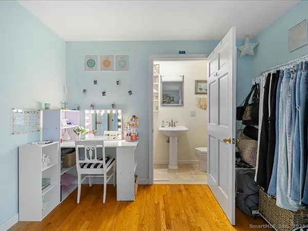 a view of a dining room with furniture a rug and wooden floor