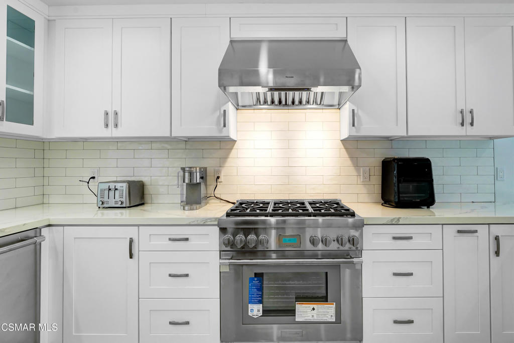 2718 Licia Place Simi Valley, CA 93065 - Photo 20 of 22 a kitchen with a stove and white cabinets