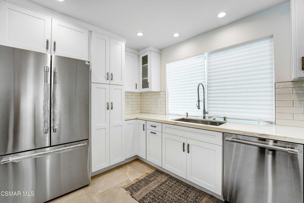 2718 Licia Place Simi Valley, CA 93065 - Photo 6 of 22 a kitchen with stainless steel appliances a refrigerator sink and cabinets