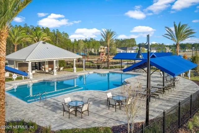 a view of a house with swimming pool and sitting area