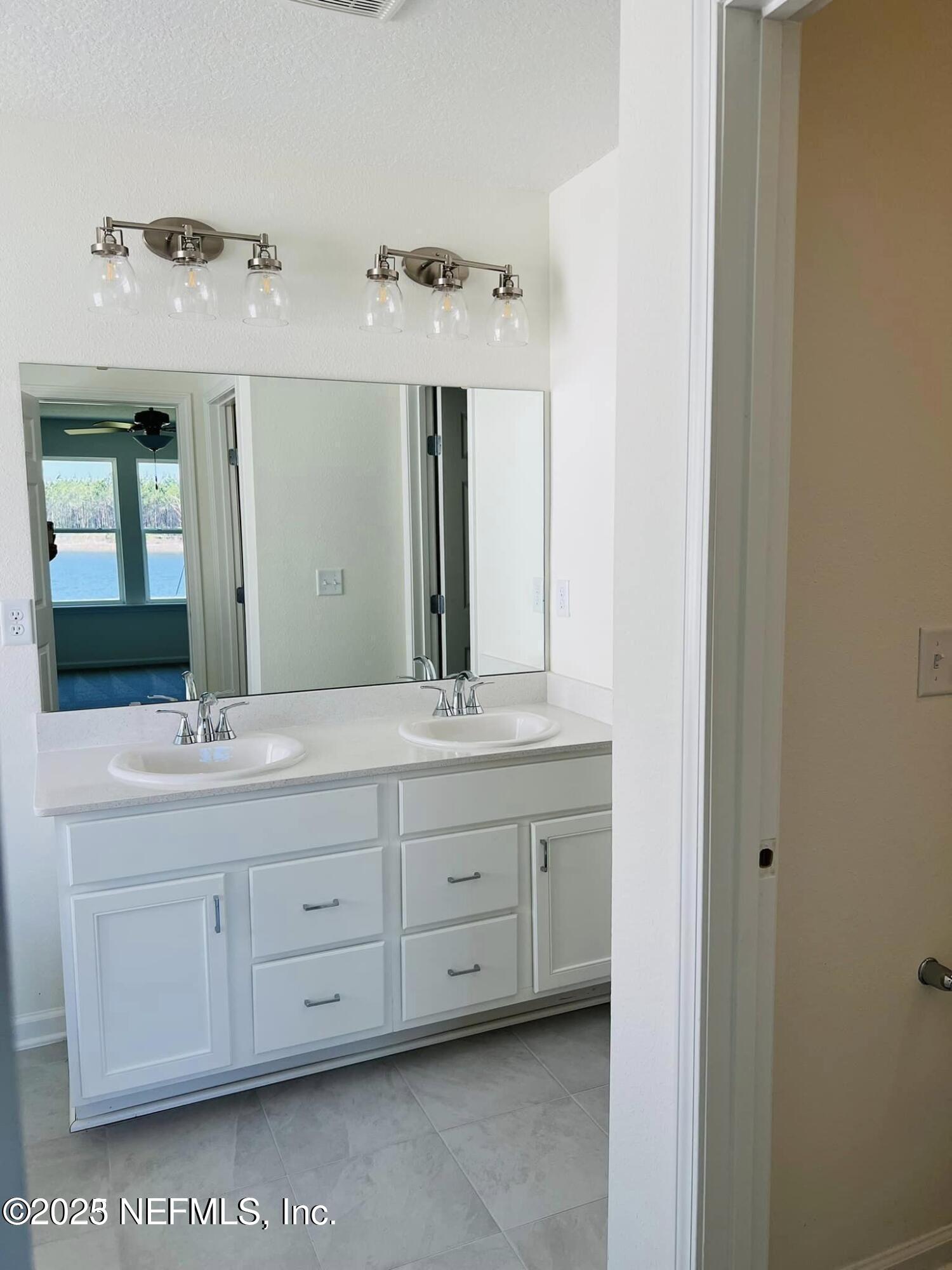 10961 Stapleton Drive Jacksonville, FL 32222 - Photo 7 of 13 a bathroom with a double vanity sink and a mirror