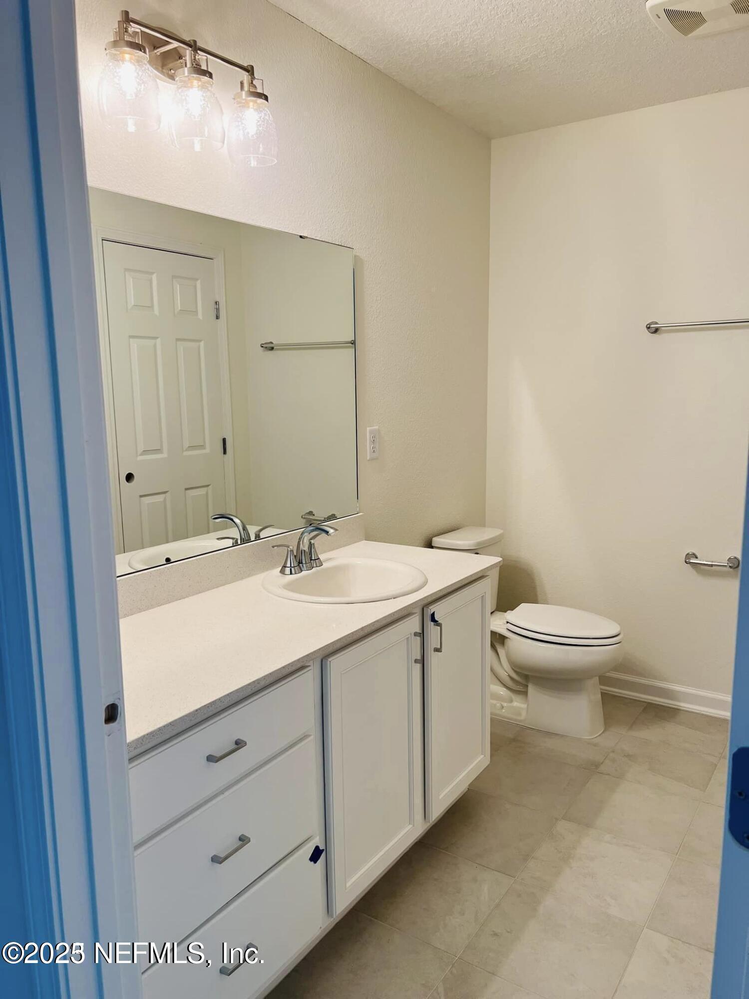 10961 Stapleton Drive Jacksonville, FL 32222 - Photo 8 of 13 a bathroom with a double vanity sink and a toilet