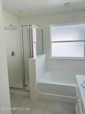 a bathroom with a bathtub and a shower