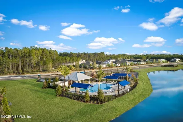 a view of a lake with houses in the back