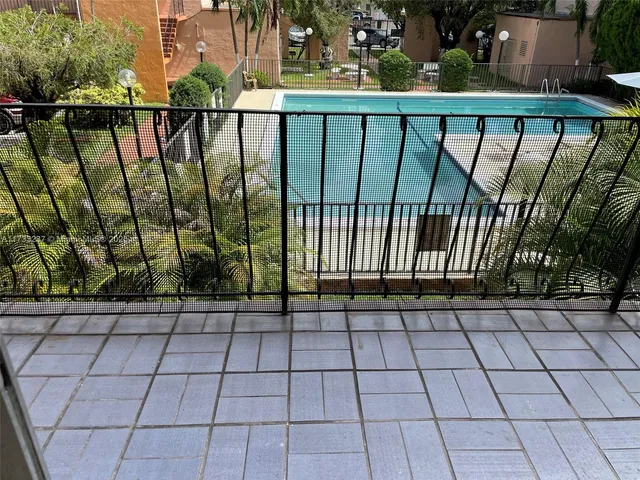 a view of a patio with table and chairs