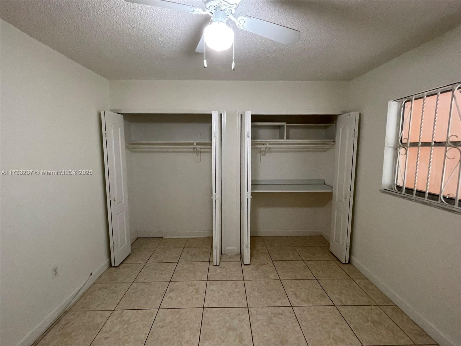 1950 West 54th Street, Unit 112 Hialeah, FL 33012 - Photo 13 of 27 an empty room with closet and windows