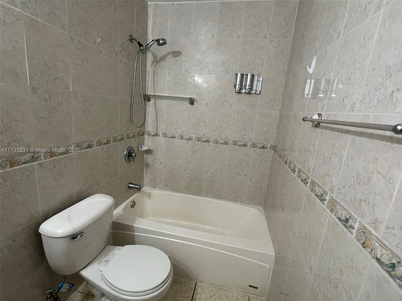 1950 West 54th Street, Unit 112 Hialeah, FL 33012 - Photo 15 of 27 a bathroom with a toilet and a bath tub