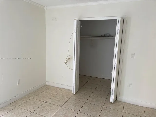 a view of a kitchen with refrigerator and sink