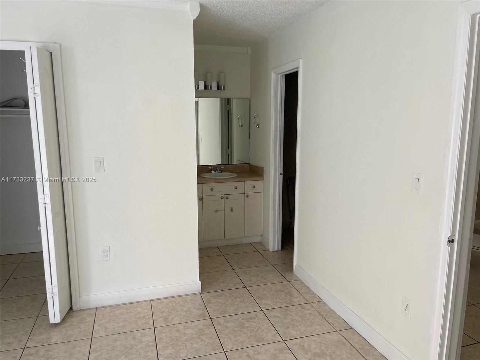 1950 West 54th Street, Unit 112 Hialeah, FL 33012 - Photo 20 of 27 a view of a kitchen with refrigerator and sink