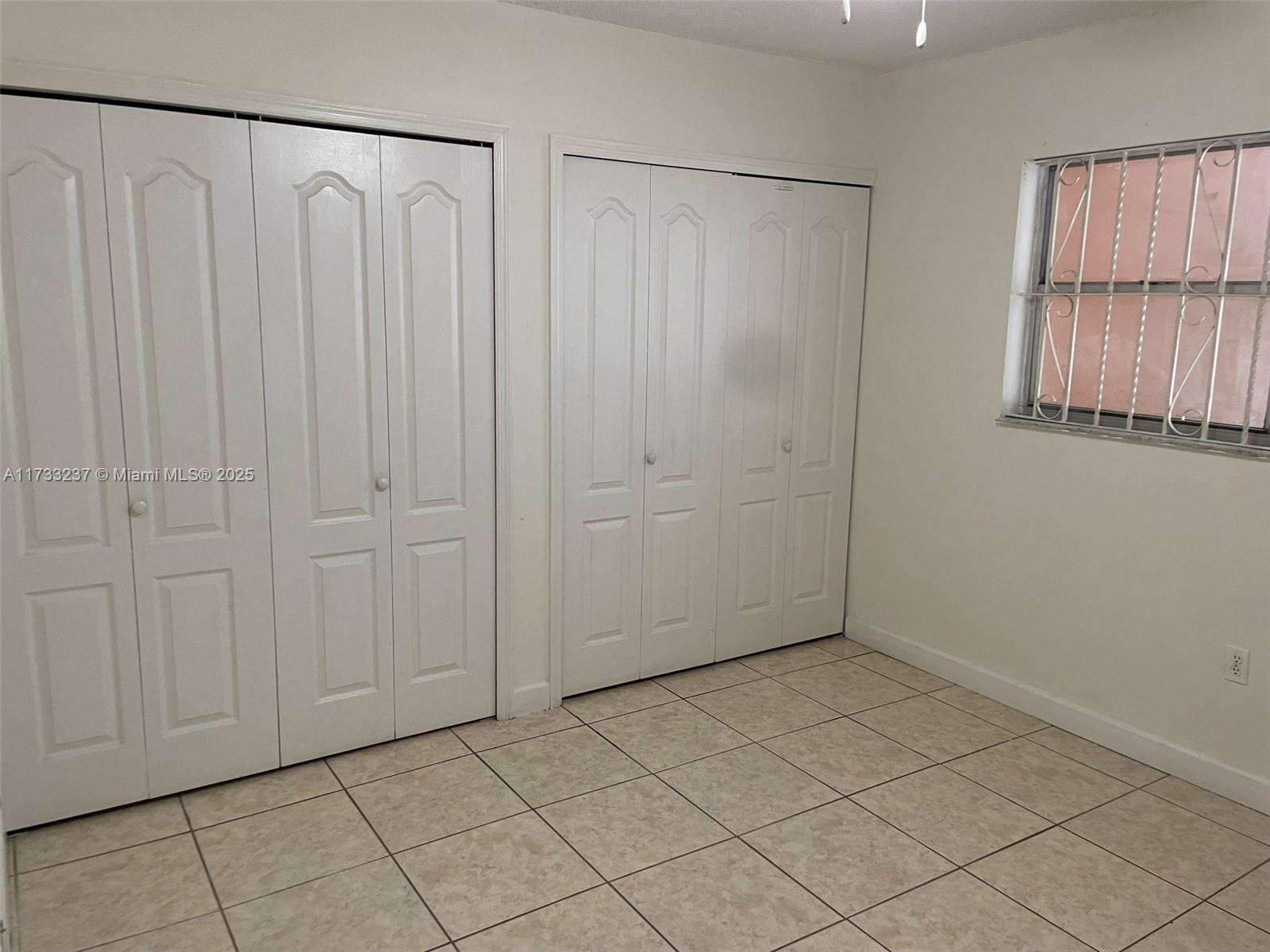 1950 West 54th Street, Unit 112 Hialeah, FL 33012 - Photo 24 of 27 a view of a closet and window in a room