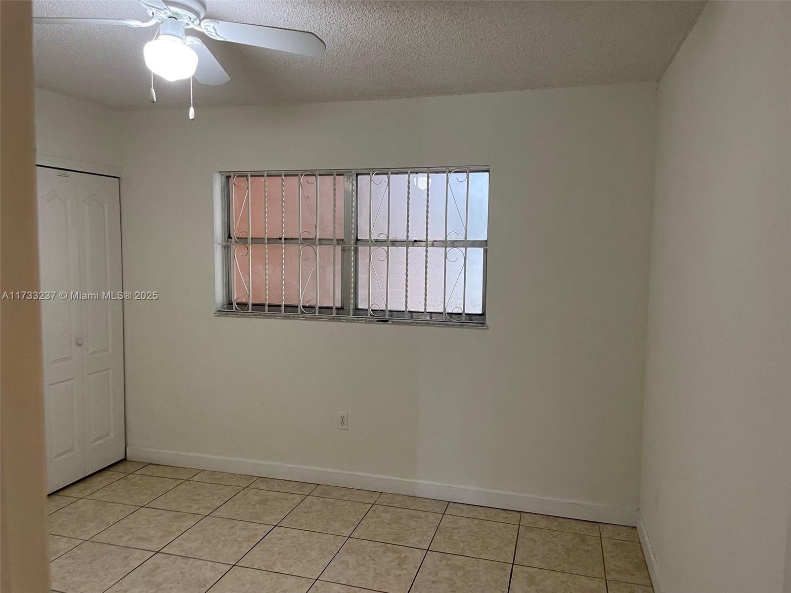 1950 West 54th Street, Unit 112 Hialeah, FL 33012 - Photo 25 of 27 an empty room with windows and fan
