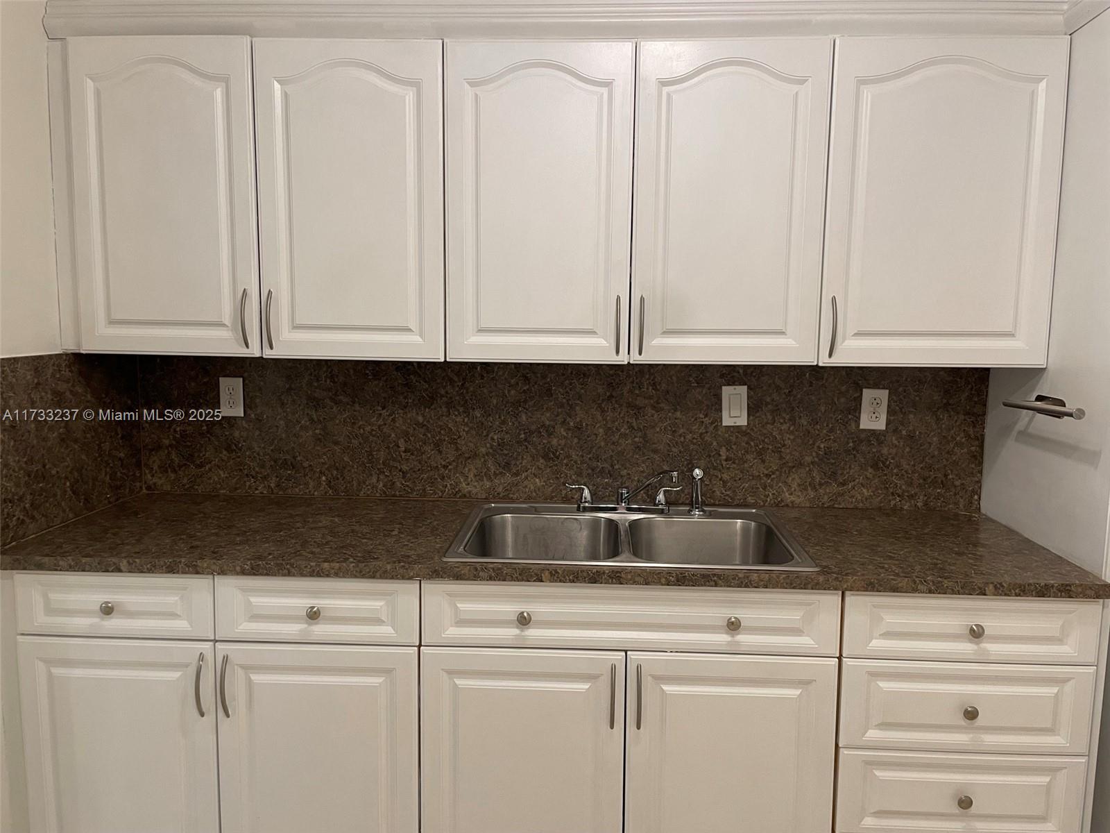 1950 West 54th Street, Unit 112 Hialeah, FL 33012 - Photo 5 of 27 a kitchen with white cabinets and white appliances