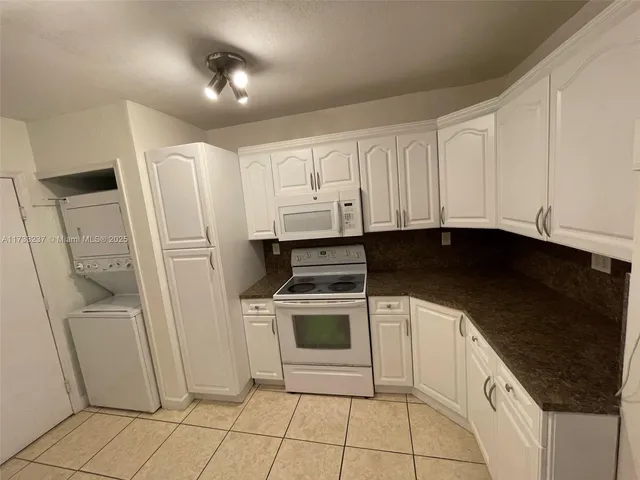 a kitchen with a stove a sink and a refrigerator