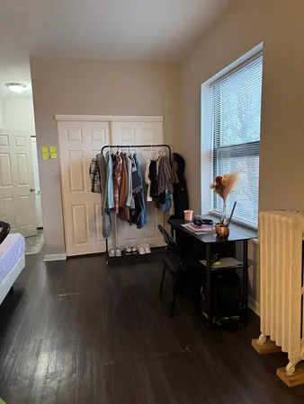 a view of a workspace with furniture and a window