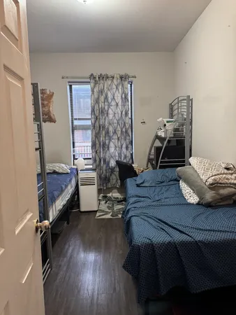 a bedroom with a bed and a chair