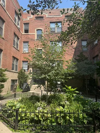an aerial view of a house with a yard and garden