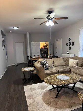 a living room with furniture and a chandelier