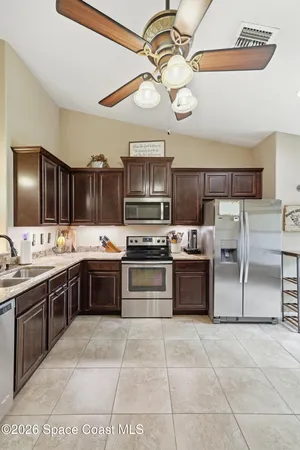 a large kitchen with cabinets and stainless steel appliances