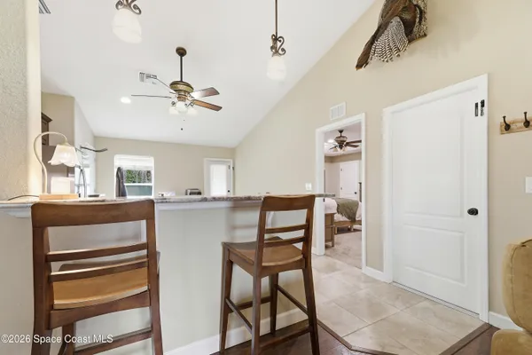a view of a dining room with furniture and a chandelier
