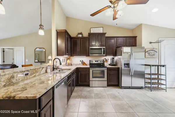a kitchen with stainless steel appliances granite countertop a sink counter space cabinets and stainless steel appliances