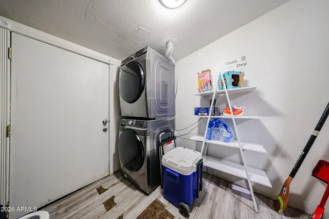 a utility room with dryer washer and a view of living room