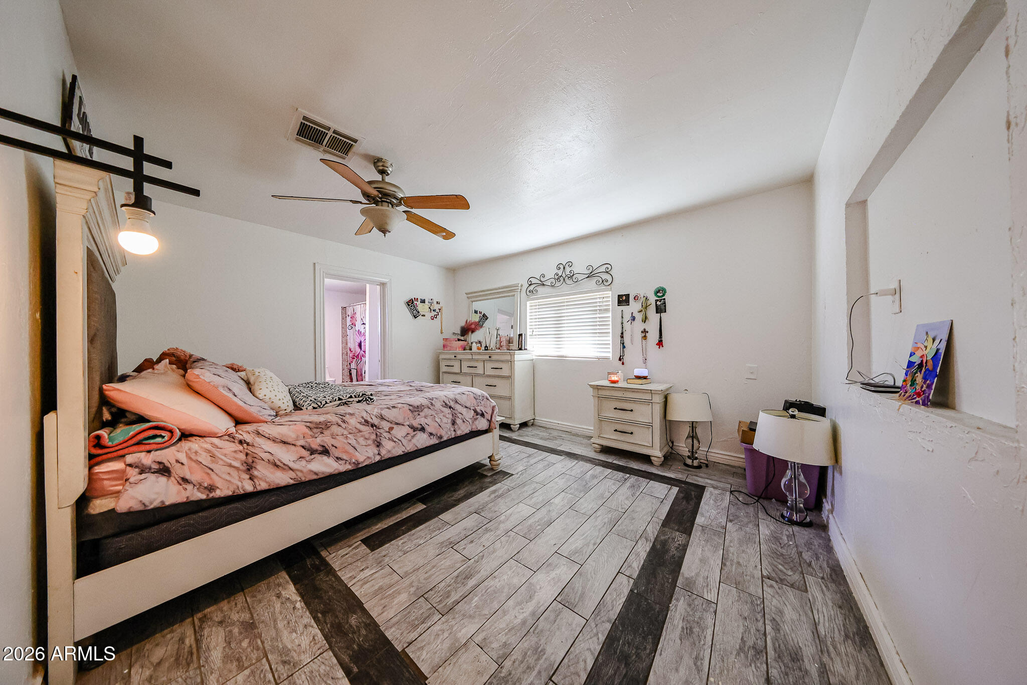 8223 C. Azteca Guadalupe, AZ 85283 - Photo 14 of 33 a bed room with a bed furniture and a wooden floor