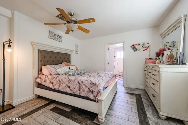 a bedroom with a bed and cabinets