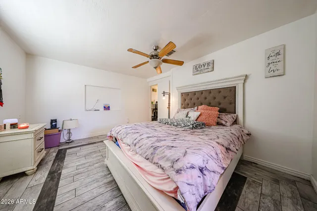 a bedroom with bed and a chandelier