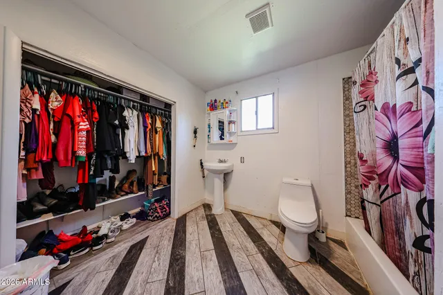 a bathroom with a toilet sink and mirror