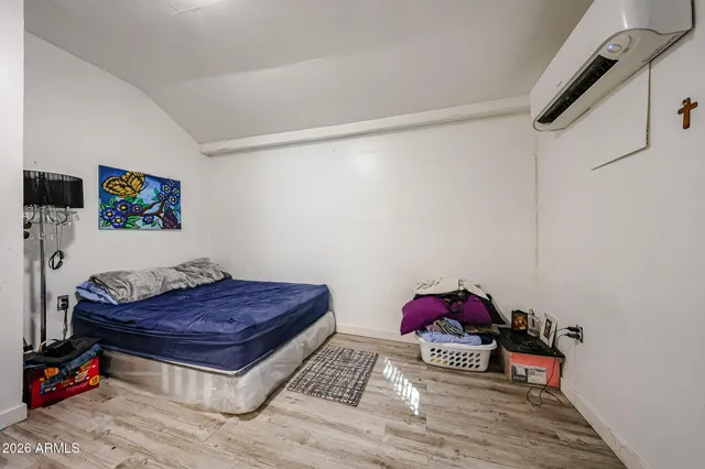 a living room with a baby crib furniture and a rug