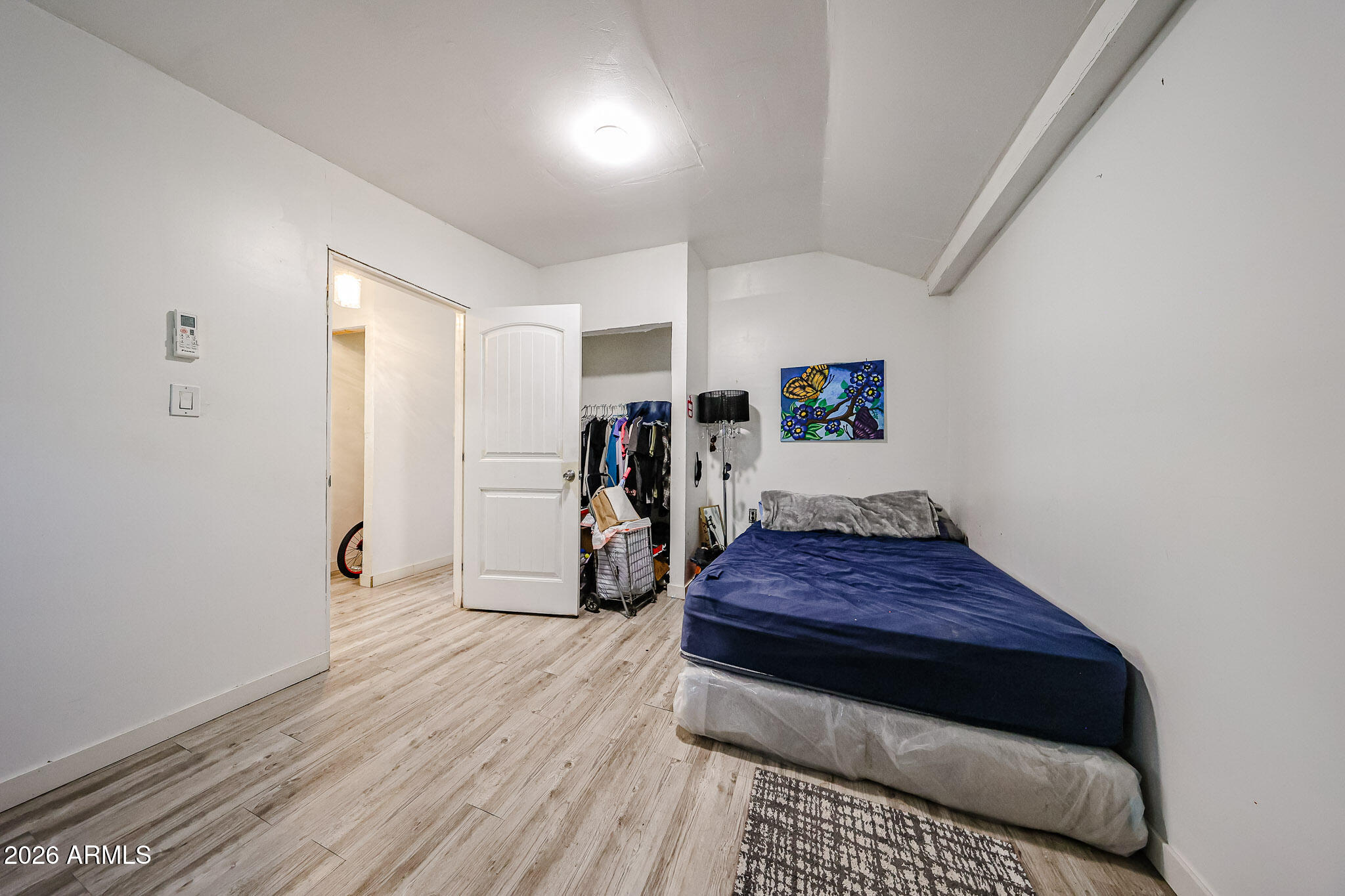 8223 C. Azteca Guadalupe, AZ 85283 - Photo 21 of 33 a bedroom with a bed and a walk in closet