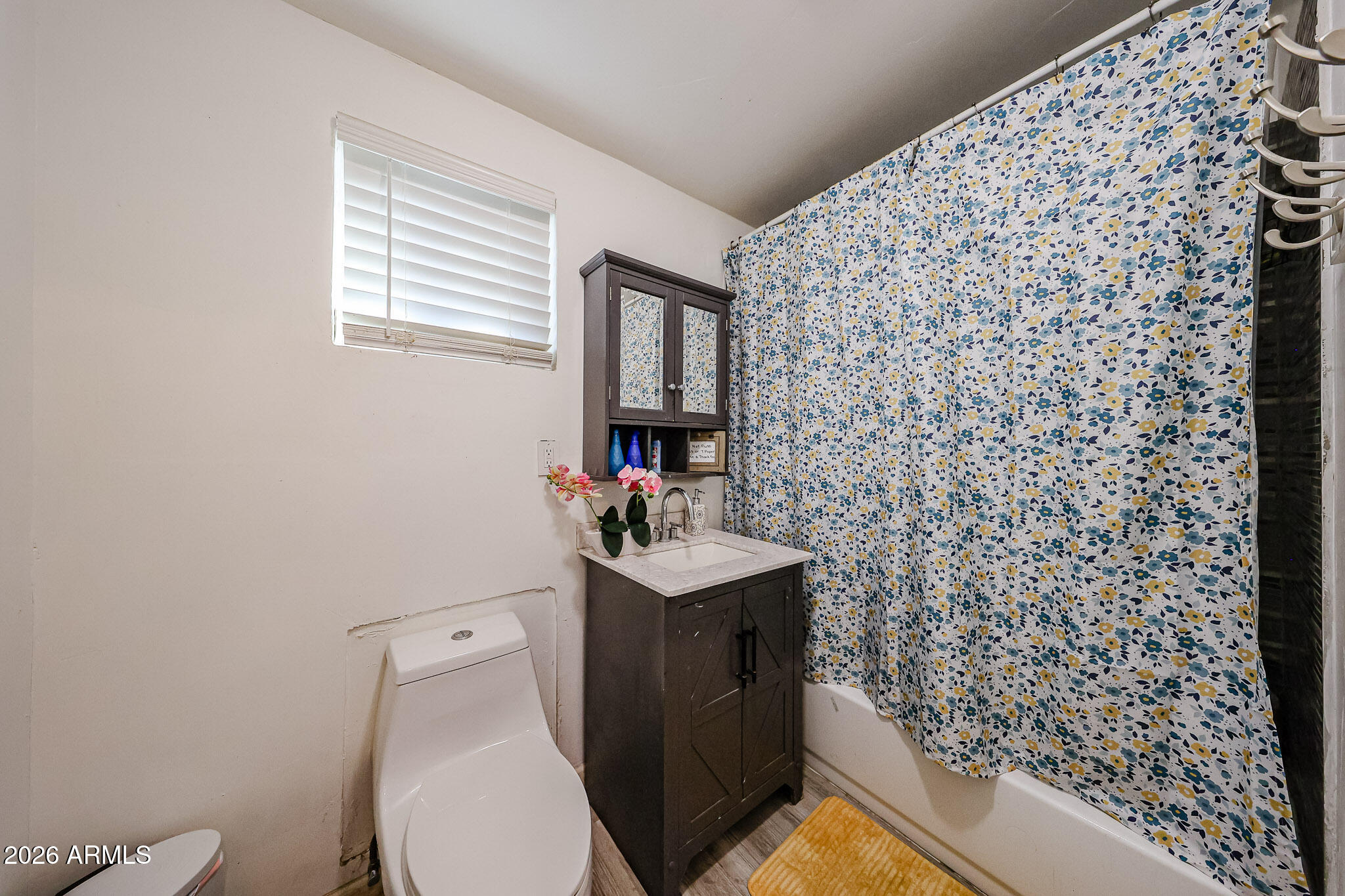 8223 C. Azteca Guadalupe, AZ 85283 - Photo 22 of 33 a bathroom with a sink toilet and mirror