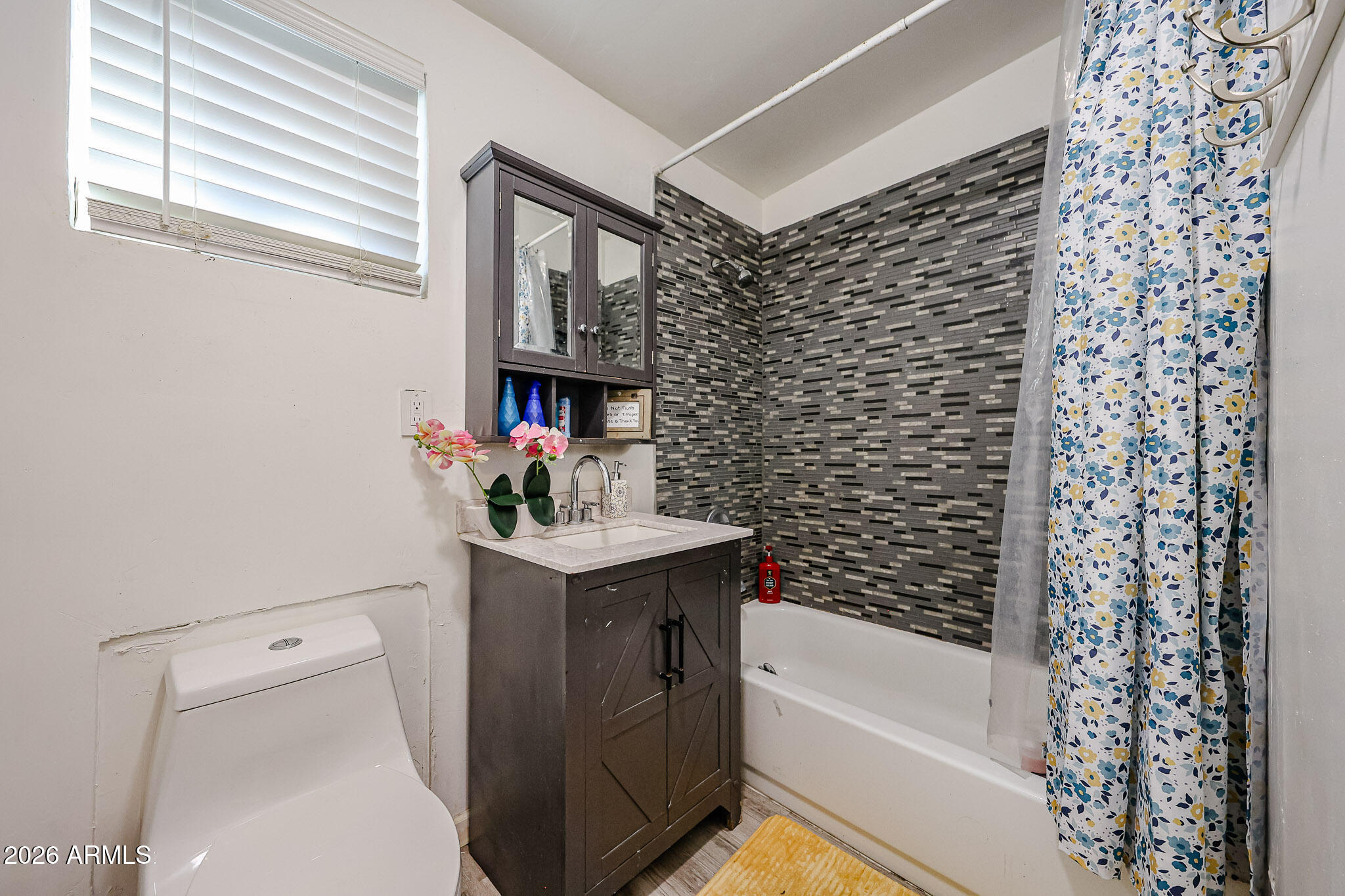 8223 C. Azteca Guadalupe, AZ 85283 - Photo 23 of 33 a bathroom with a sink toilet and shower