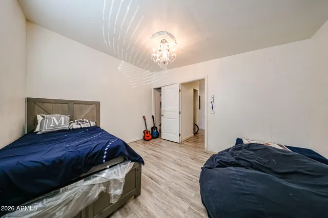 a bedroom with a bed and a chandelier