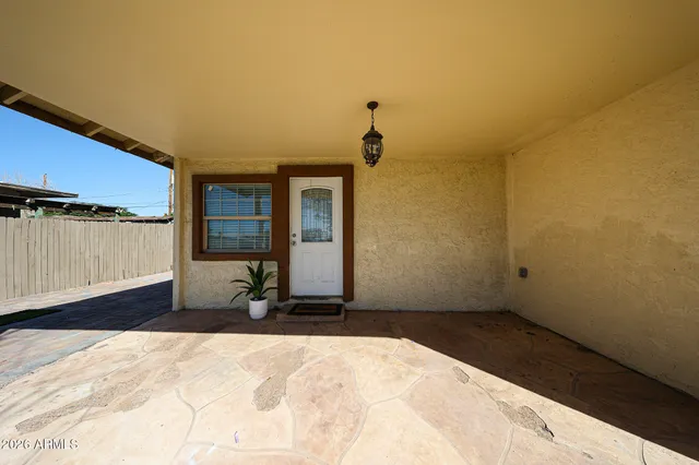 a view of a backyard with table and chairs and potted plants