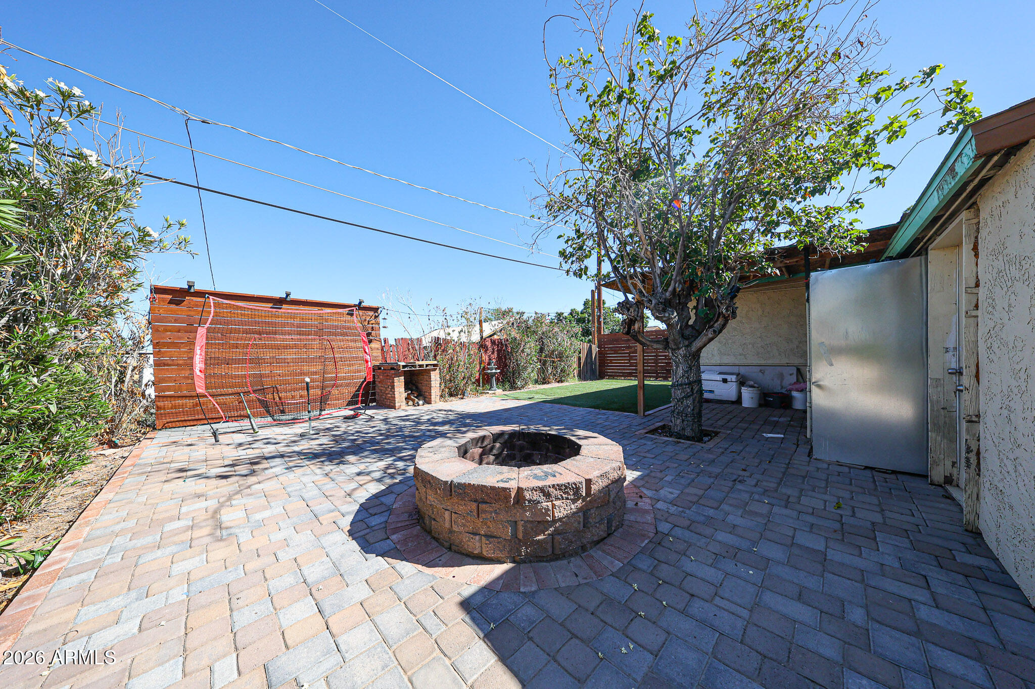 8223 C. Azteca Guadalupe, AZ 85283 - Photo 28 of 33 a view of a backyard with table and chairs and potted plants