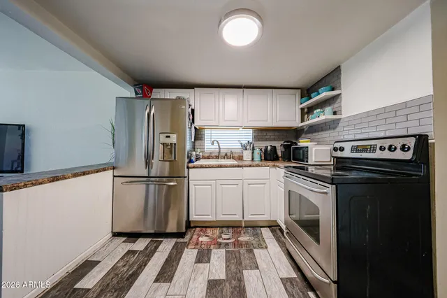 a kitchen with a refrigerator sink and stove