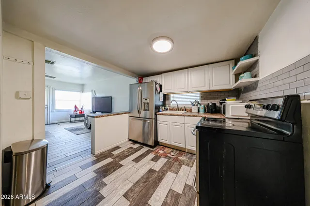 a kitchen with sink refrigerator and cabinets
