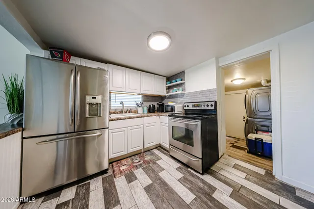 a kitchen with stainless steel appliances a refrigerator sink and microwave