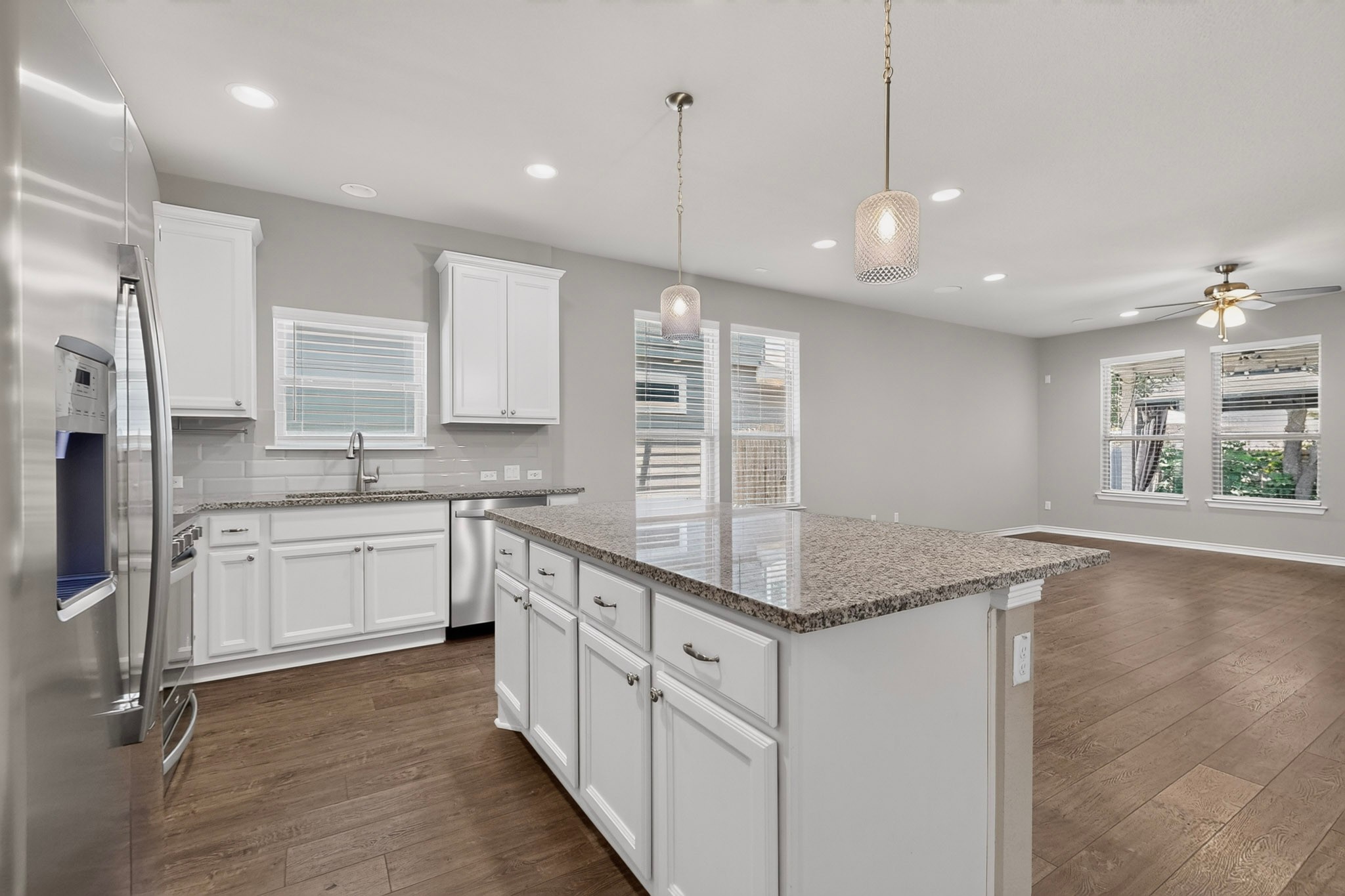 1908 Turtle Bay Loop Leander, TX 78641 - Photo 12 of 38 A gourmet kitchen boasts granite counters, white cabinetry, and a spacious island.