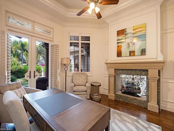 a living room with furniture a fireplace and windows