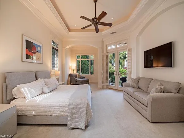 a living room with furniture ceiling fan and a flat screen tv