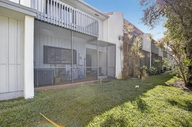 a view of a house with a small yard and wooden fence