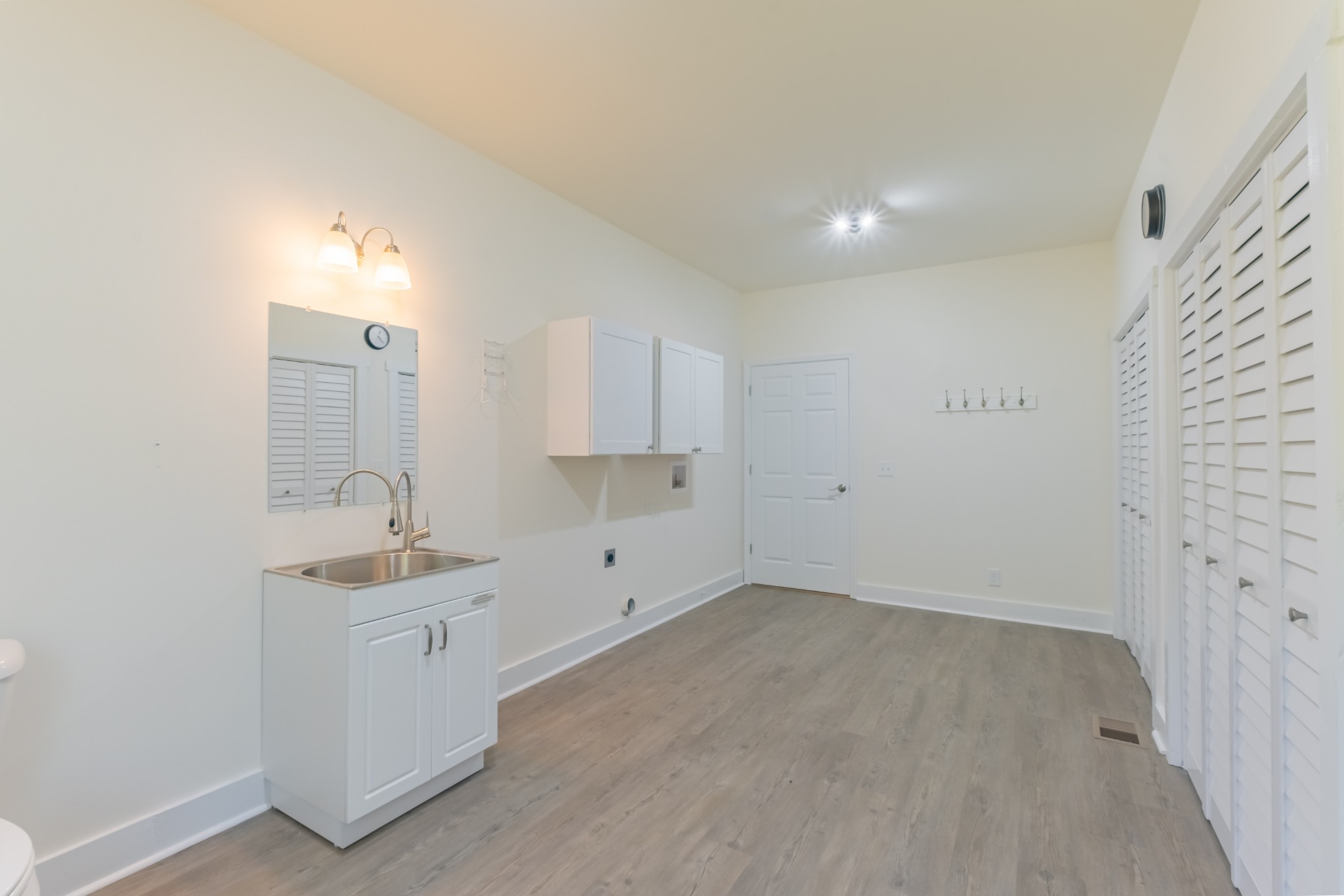 959 Ferrells Loop Road Manchester, TN 37355 - Photo 24 of 55 a view of a kitchen with white cabinets and wooden floor