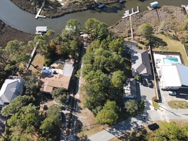 an aerial view of a house with a yard and lake view