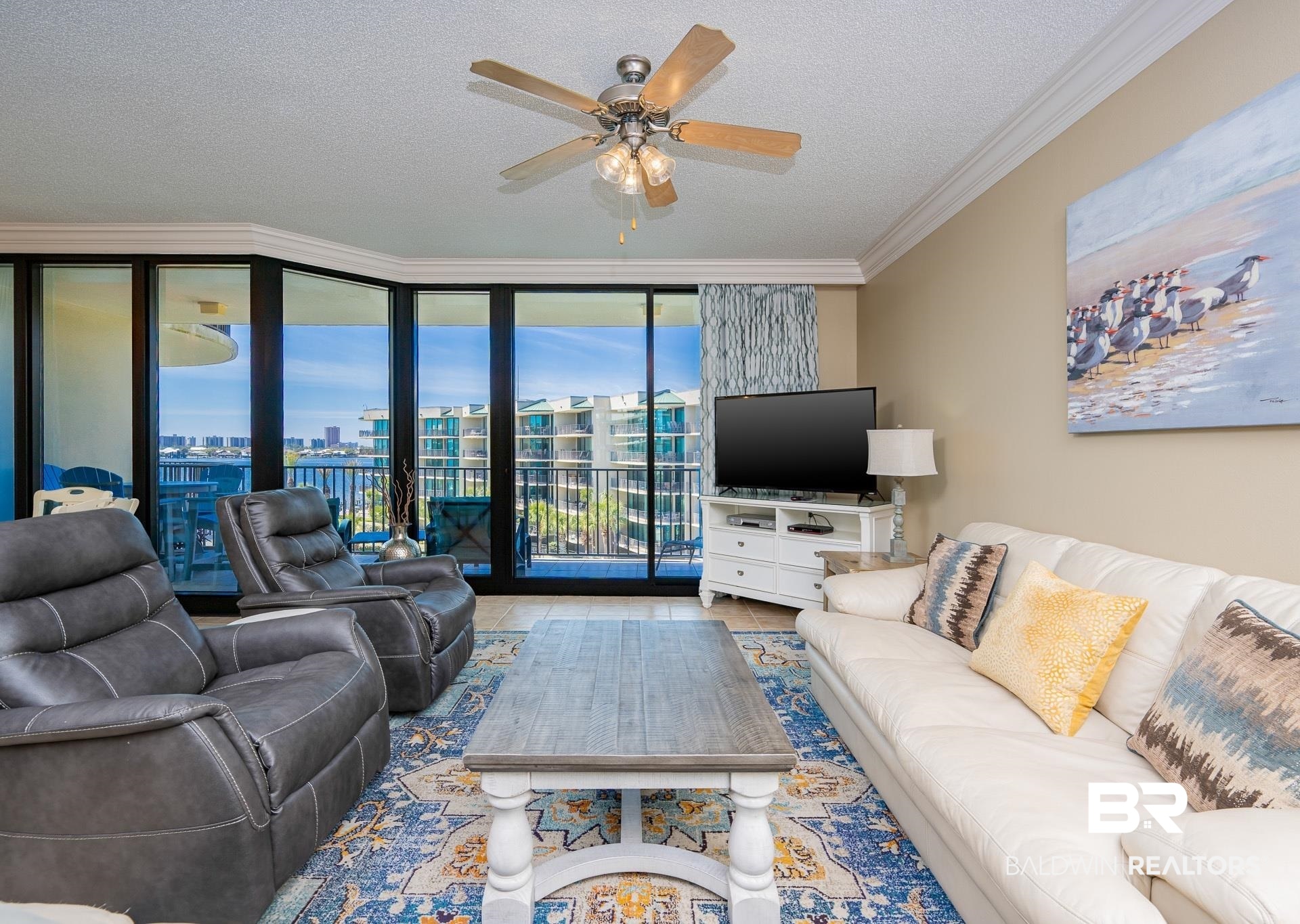 27580 Canal Road, Unit 1429 Orange Beach, AL 36561 - Photo 2 of 45 Living area featuring expansive windows, a textured ceiling, ceiling fan, crown molding, and tile patterned floors