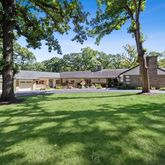 a view of house with backyard space and garden