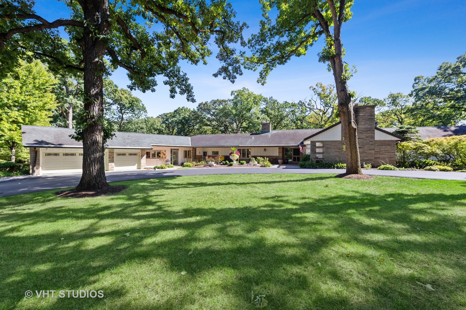 6547 South County Line Road Burr Ridge, IL 60527 - Photo 2 of 59 a view of house with outdoor space and garden